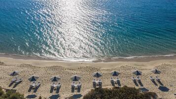 On the beach, white sand, sun-loungers, beach umbrellas