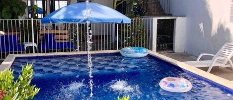 Outdoor pool, open 9:00 AM to 9:00 PM, pool umbrellas