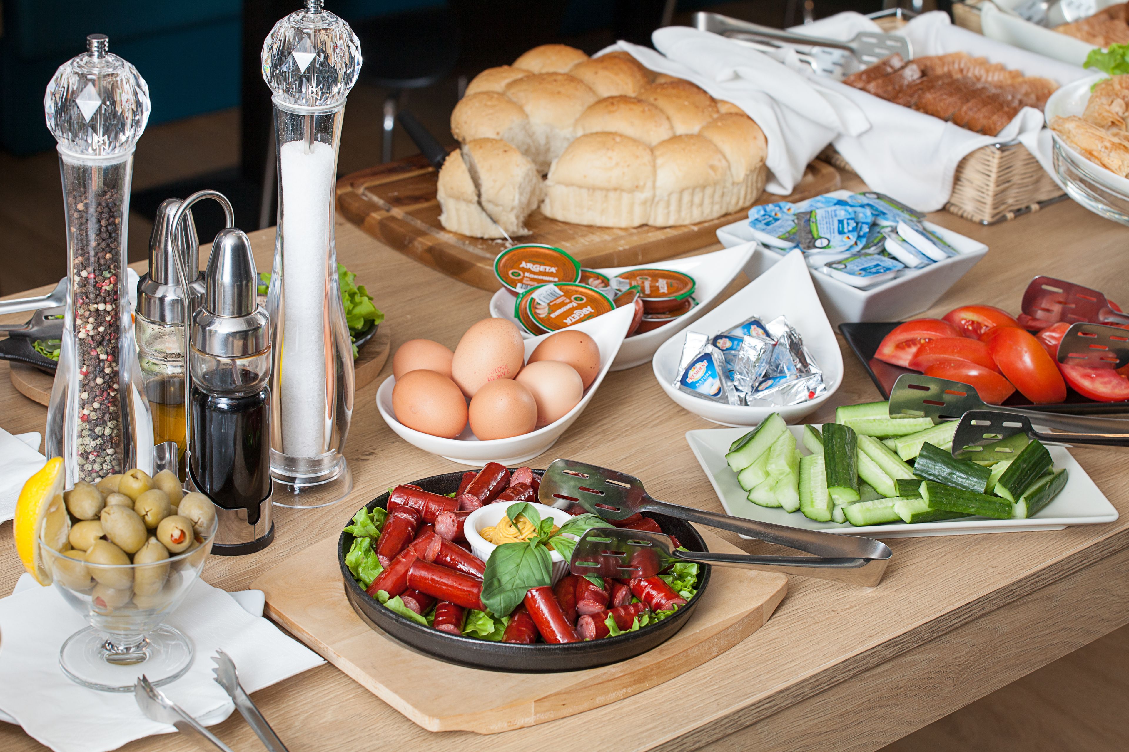 A breakfast buffet with various food items and condiments.