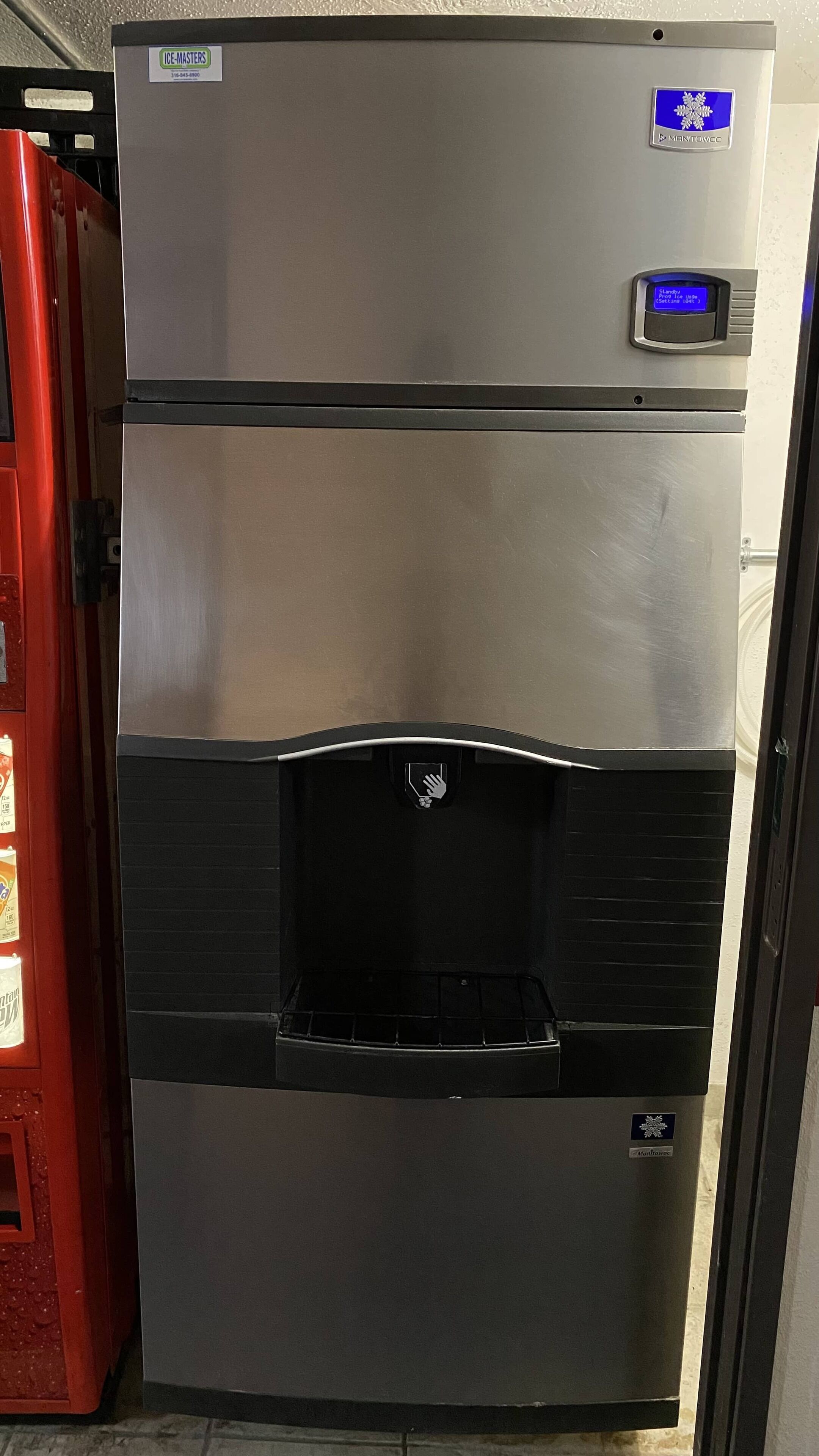 A stainless steel refrigerator with a freezer compartment, a water dispenser, and a control panel.