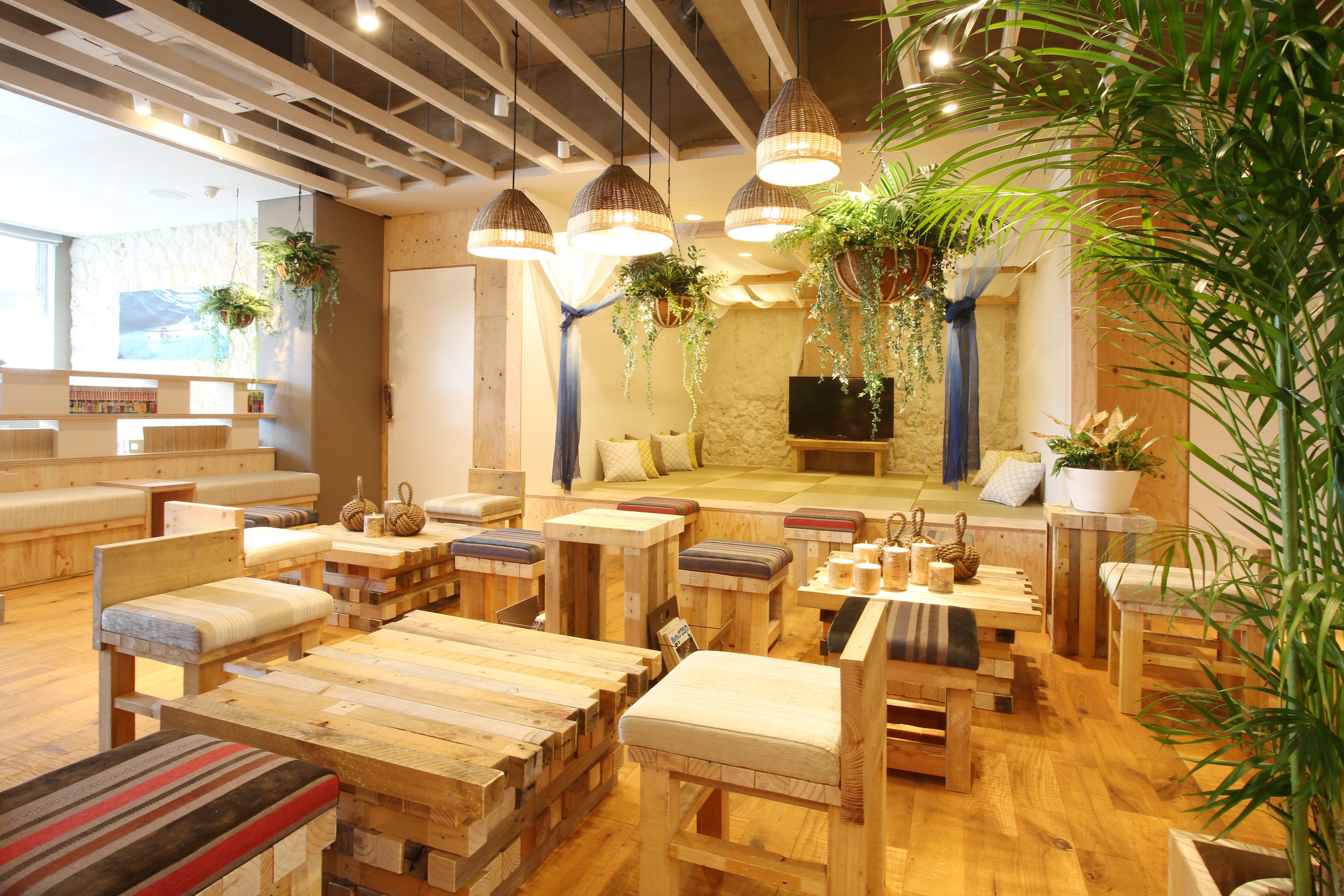 A cozy, rustic-style room with wooden furniture, hanging plants, and a television.