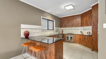 House, 4 Bedrooms, 2 Bathrooms | Private kitchen | Full-sized fridge, microwave, oven, stovetop