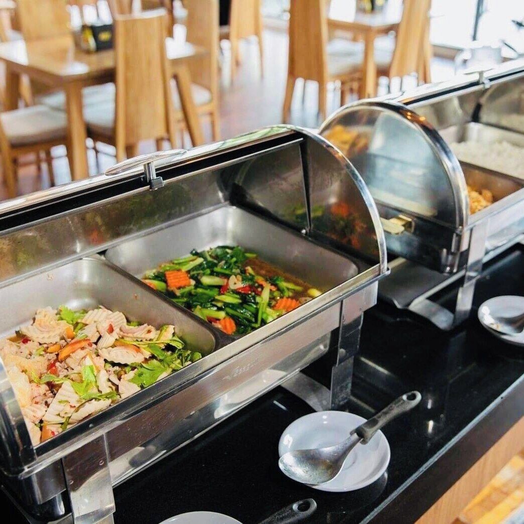 A buffet with various dishes including salads and stir-fried vegetables.