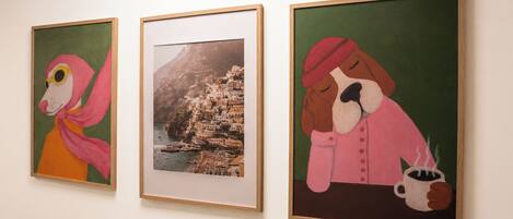 Three framed artworks on a wall.