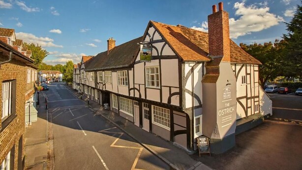 A traditional Tudor-style building with a sign reading "The Ostrich."