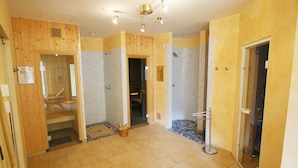 A hotel bathroom with wooden walls, a shower area, and a glass door. - Landhotel Kreinerhof - Self Check In 24h möglich (Lurnfeld)