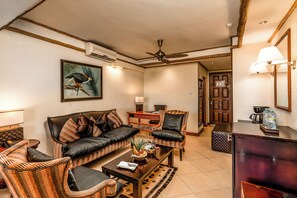 Superior Room | Living area | 42-inch flat-screen TV with satellite channels - Chobe Safari Lodge | East Africa Uganda (Karuma)
