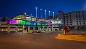 A Grand Casino building at dusk with a prominent sign, illuminated entrance, and a well-lit parking area. - Grand Casino Mille Lacs Hotel (Onamia)