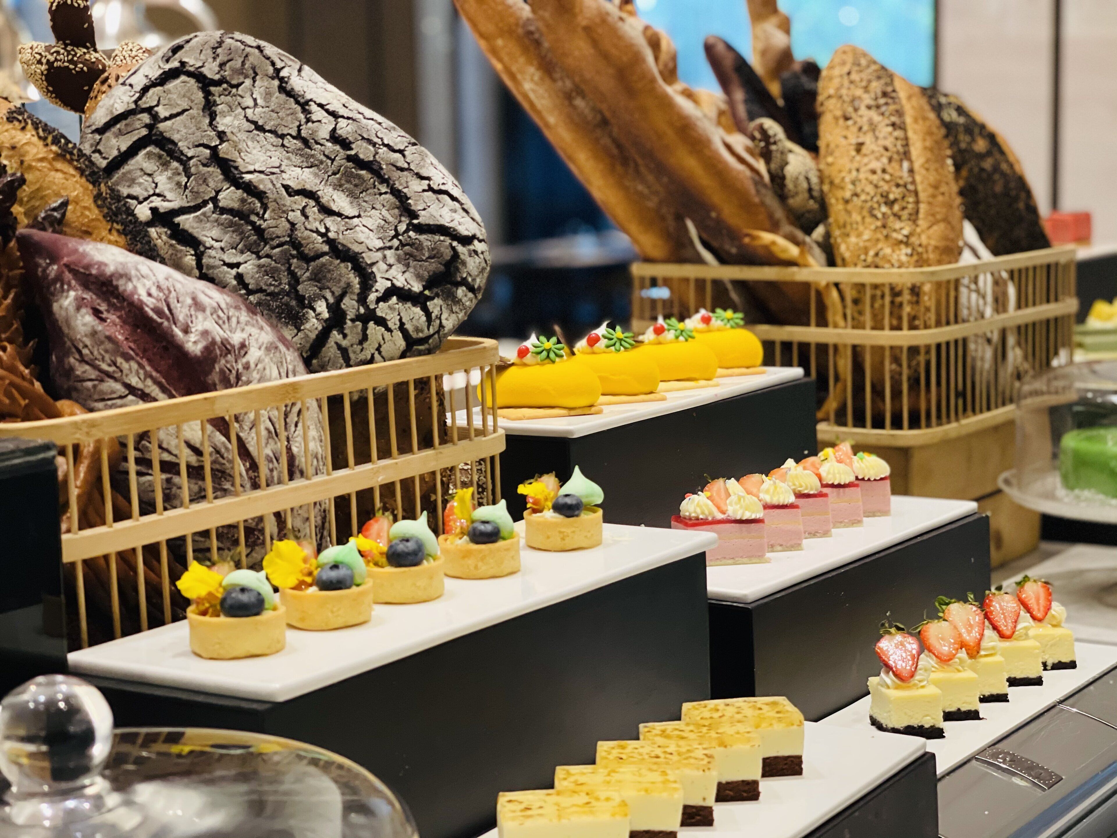 A variety of desserts and pastries displayed on a buffet table.