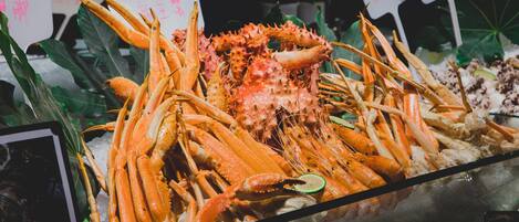 A seafood display with various types of crabs and lobsters on ice.