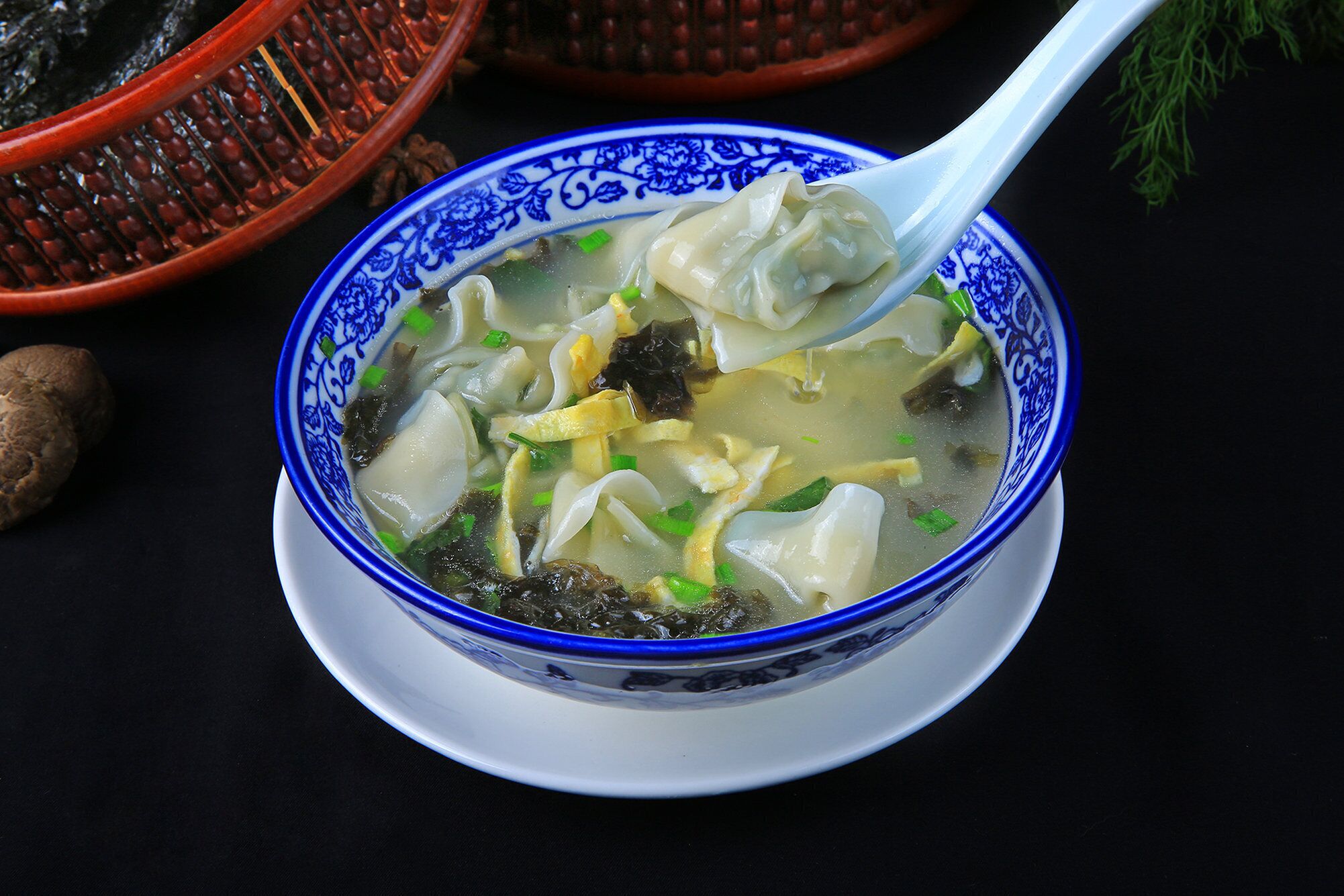 Eine Schüssel Suppe mit Knödeln, Seetang und Frühlingszwiebeln.