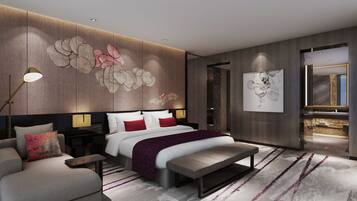 A modern bedroom with a large bed, a bedside table, a chair, and a bench.