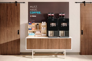 A coffee station with two coffee machines and a variety of coffee pods and cups. - Holiday Inn Express & Suites McAllen - Medical Center Area by IHG (McAllen)