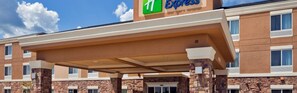 A 1 Express hotel with a covered entrance, stone pillars, and a brick facade. - Holiday Inn Express & Suites McAllen - Medical Center Area by IHG (McAllen)