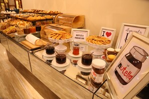 A buffet with waffles, pancakes, and various spreads.