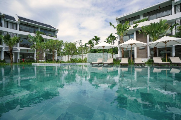Una piscina al aire libre, sombrillas, tumbonas
