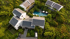 A large, modern resort with multiple buildings, a swimming pool, and lush greenery. - Senvila Boutique Resort & Spa (Da Nang)