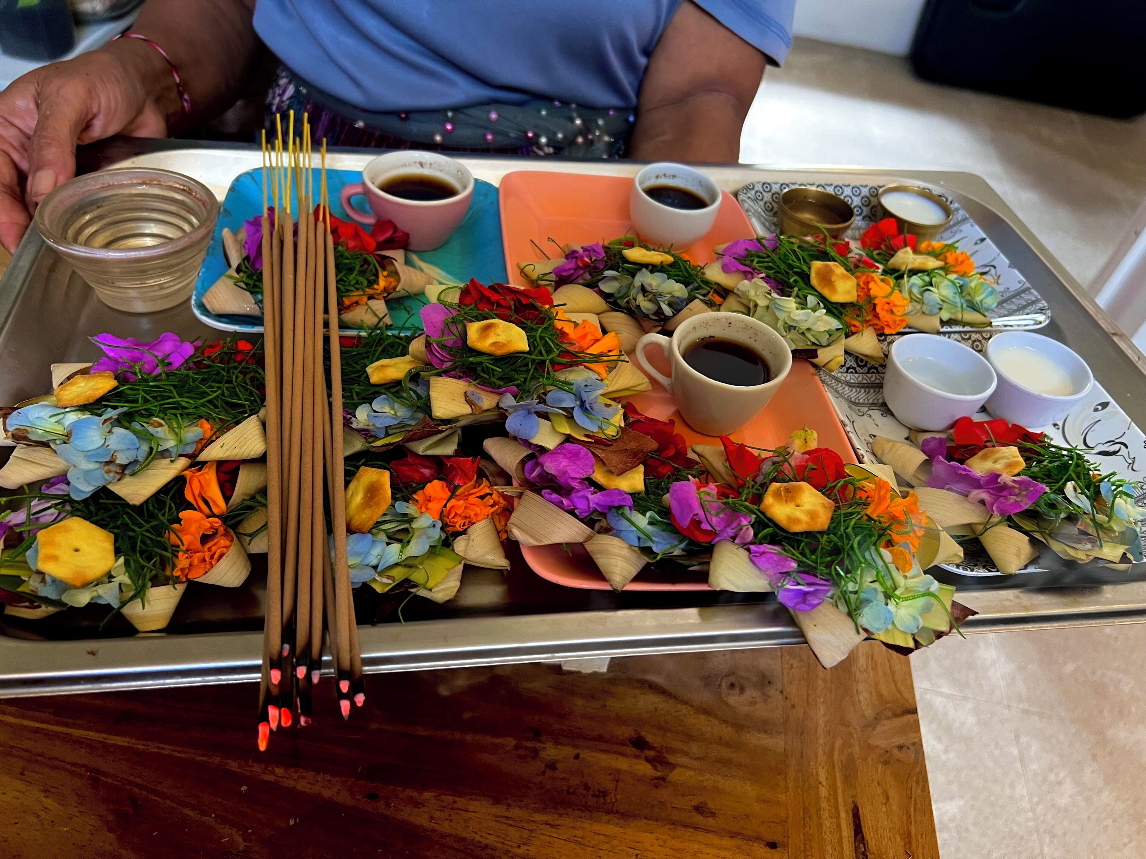 A tray with food items, including a cup of tea, a bowl of soup, and various snacks.