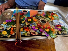 A tray with food items, including a cup of tea, a bowl of soup, and various snacks.