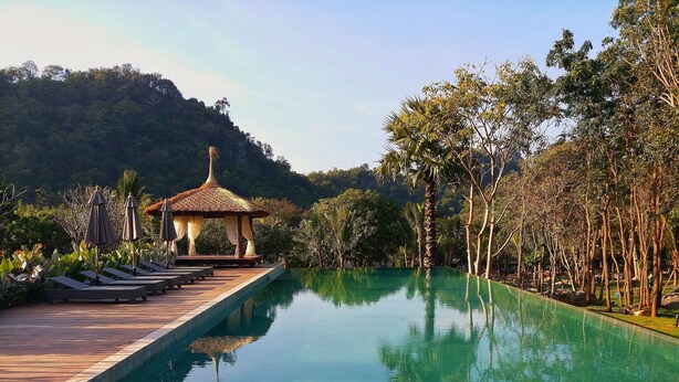A serene pool area with lounge chairs and a gazebo. - The Series Resort Khaoyai (Pak Chong)