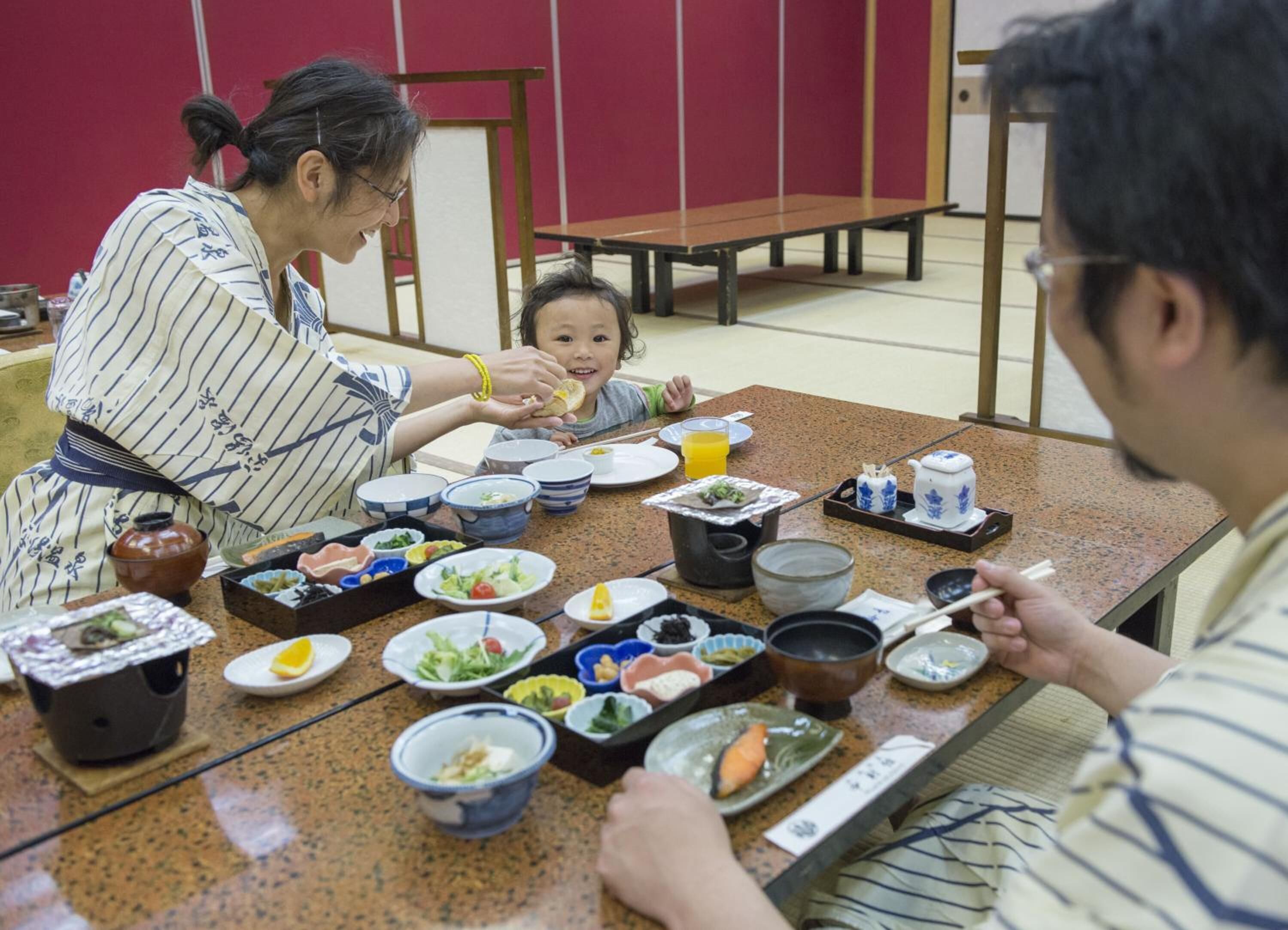 A traditional Japanese meal setting with various dishes and utensils on a table.