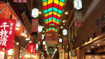 An indoor market with various stalls and hanging signs.