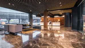 A modern lobby with a polished marble floor, a reception desk, and seating areas. - AC Hotel by Marriott Puchong (Puchong)