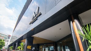 A modern hotel entrance with a prominent logo, glass doors, and a clean, contemporary design. - AC Hotel by Marriott Puchong (Puchong)