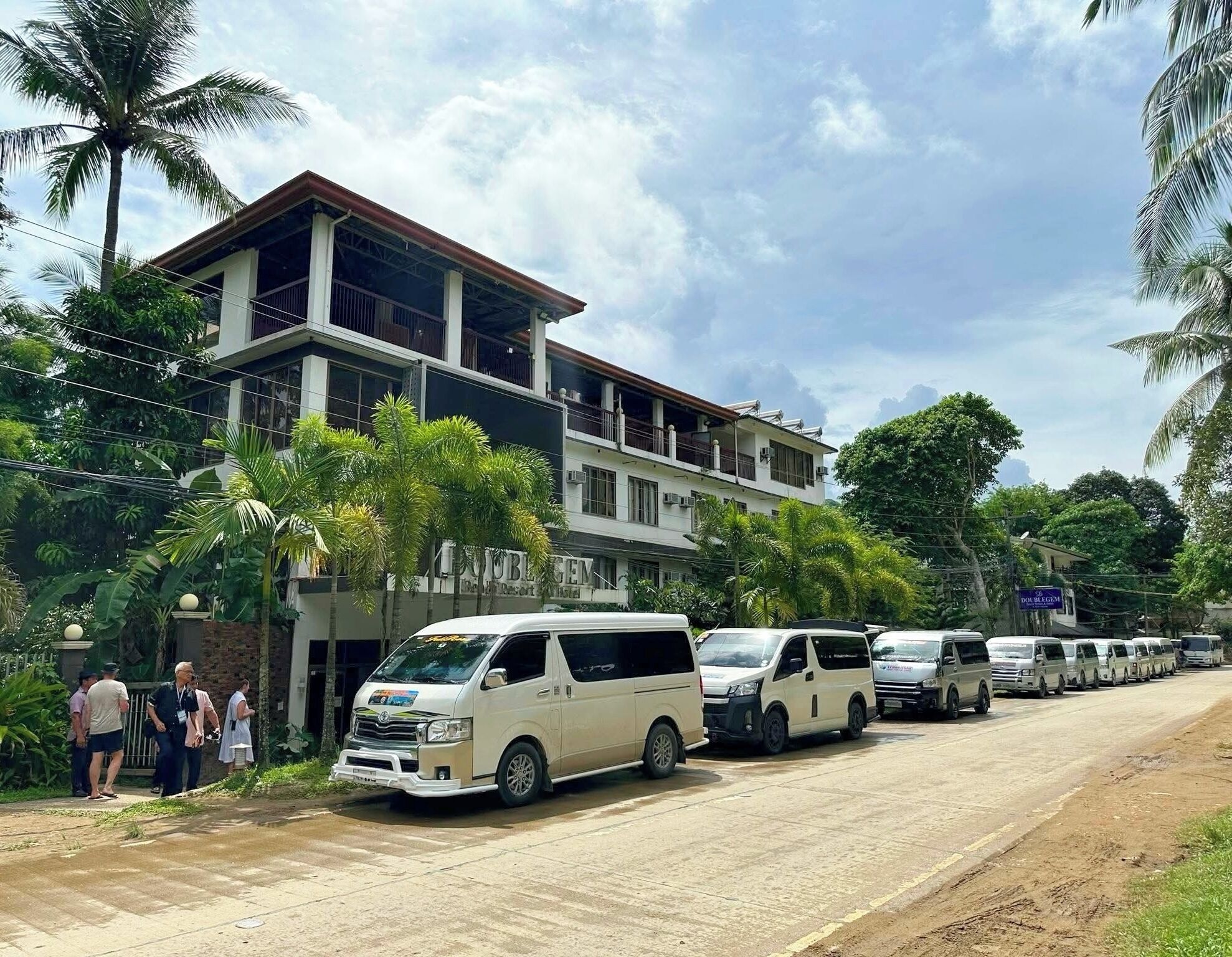 A multi-story building with a sign indicating it is a hotel.
