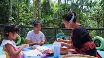Guests can enjoy a casual gathering in our garden area, surrounded by lush greenery.