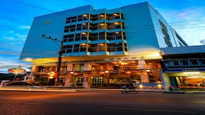 A multi-story hotel with a modern design, featuring a prominent entrance with illuminated signage and a well-lit facade. - Lake Inn Hotel (Songkhla)