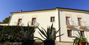 A two-story building with balconies and potted plants in the foreground. - BBuSS Country Club (Catanzaro)