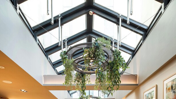 A spacious indoor area with high ceilings, large windows, and multiple seating arrangements including tables and couches. - Point A London Shoreditch (London)