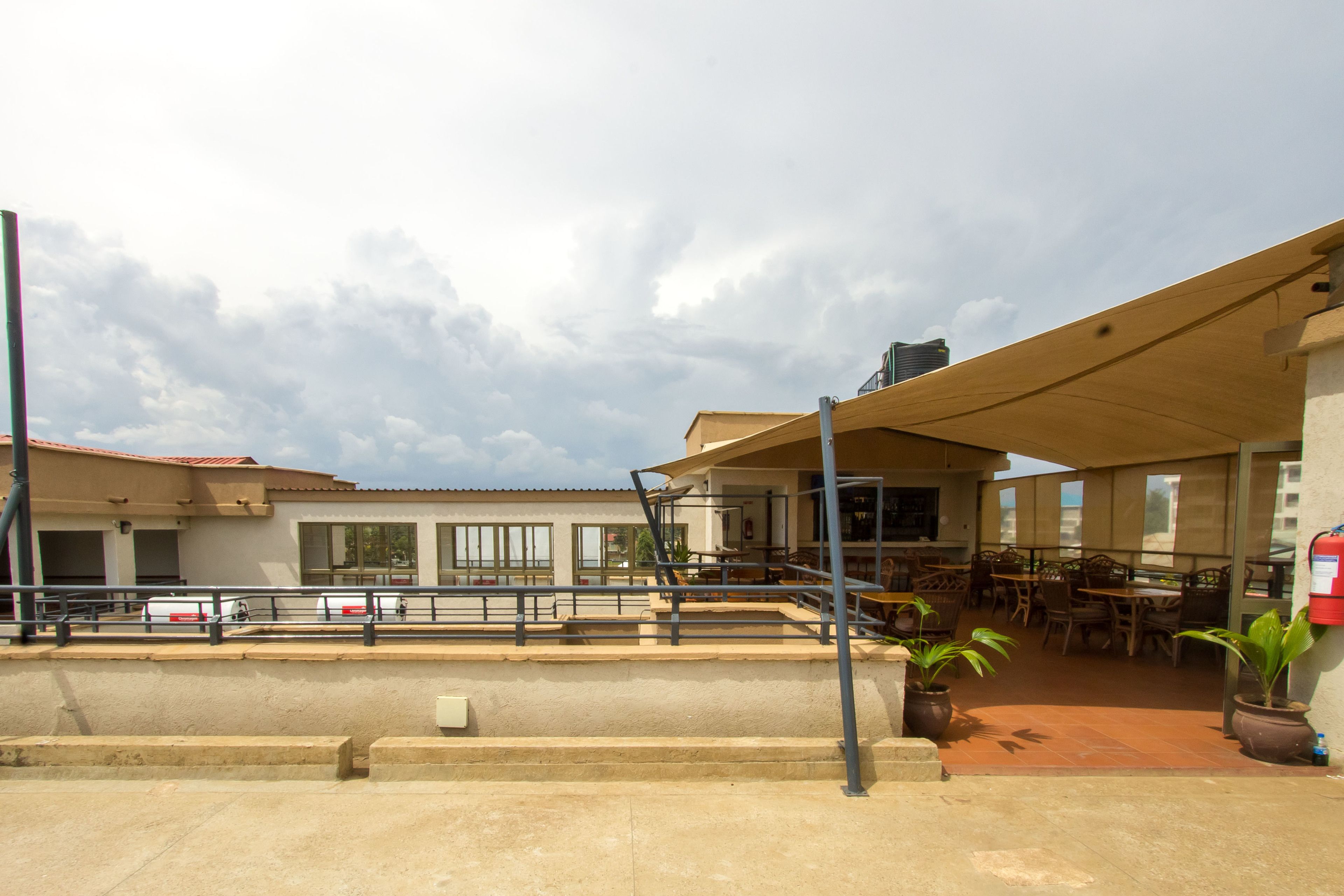 A building with outdoor seating, a covered area, and a fire extinguisher.