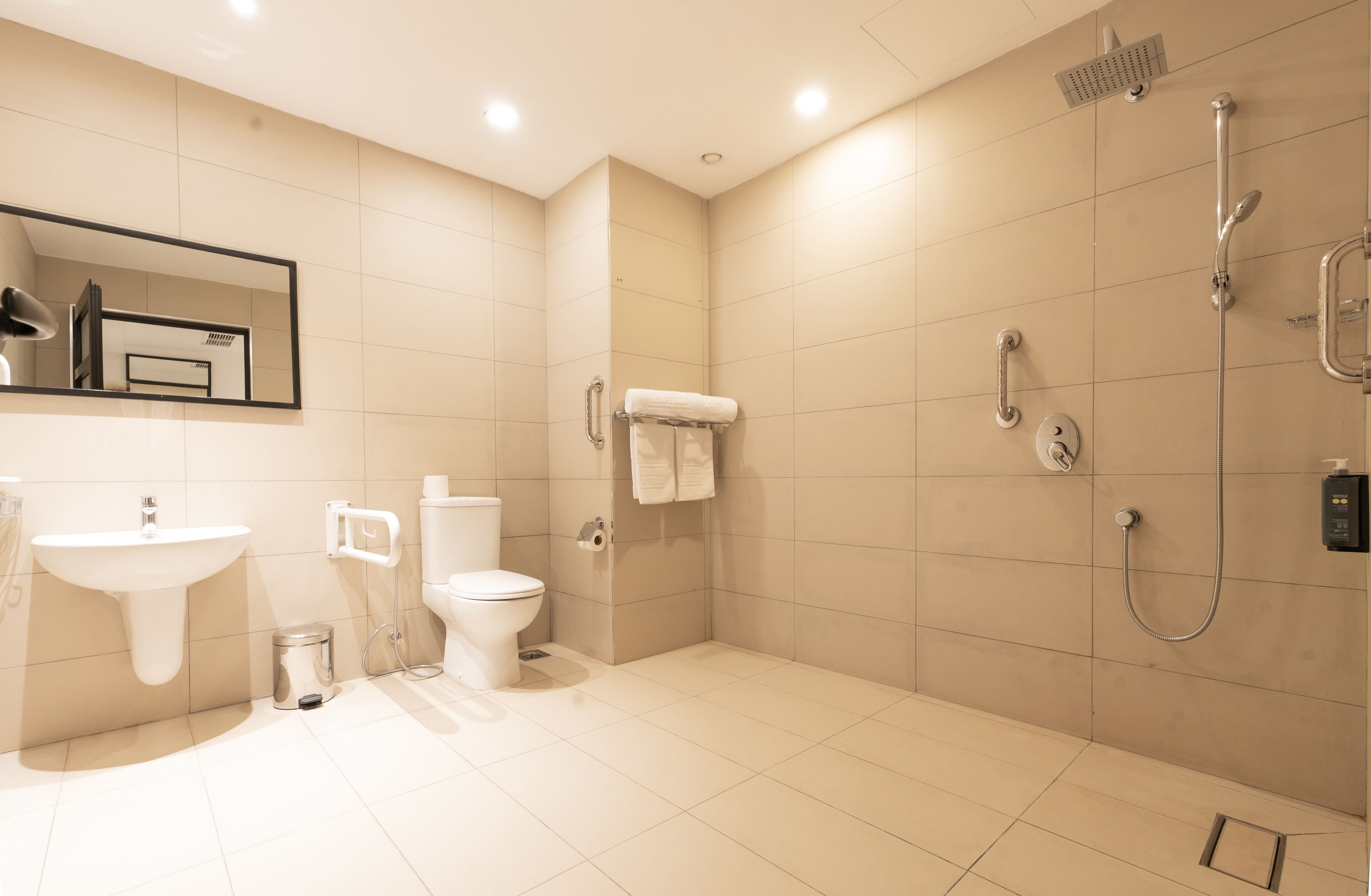 A modern bathroom with a sink, toilet, and shower.