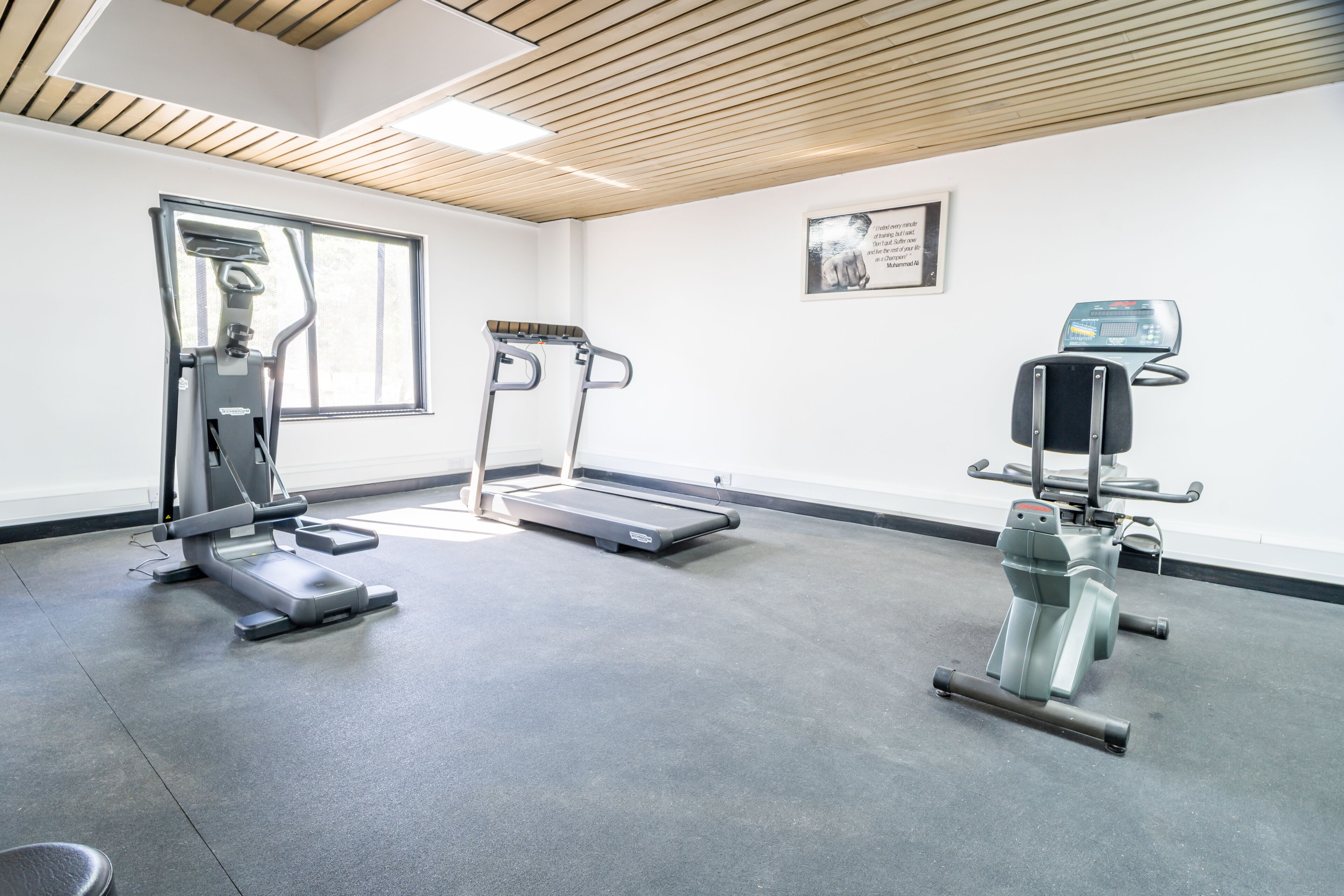 A gym with treadmills, a stationary bike, and a weight machine.