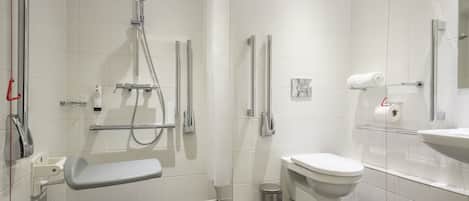 A modern bathroom with a shower, toilet, and sink.