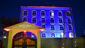 The Wuduria Hotel with a prominent entrance and a facade illuminated in blue. - Wuduria Hotel (Nairobi)
