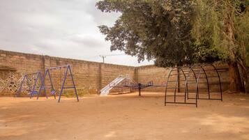 Children can play on swings and a climbing frame in this designated play area.