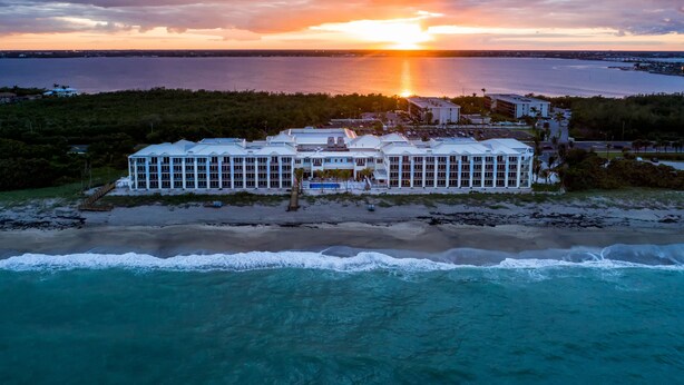 A beachfront hotel with multiple buildings, a pool, and a beach view. - Hutchinson Shores Resort & Spa (Jensen Beach)