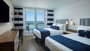 A hotel room with two beds, a desk, and a view of the ocean. - Hutchinson Shores Resort & Spa (Jensen Beach)
