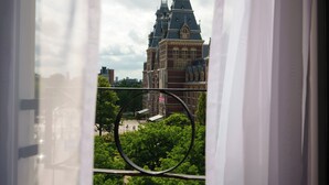 A view of a historic building with a prominent tower and a circular window frame.