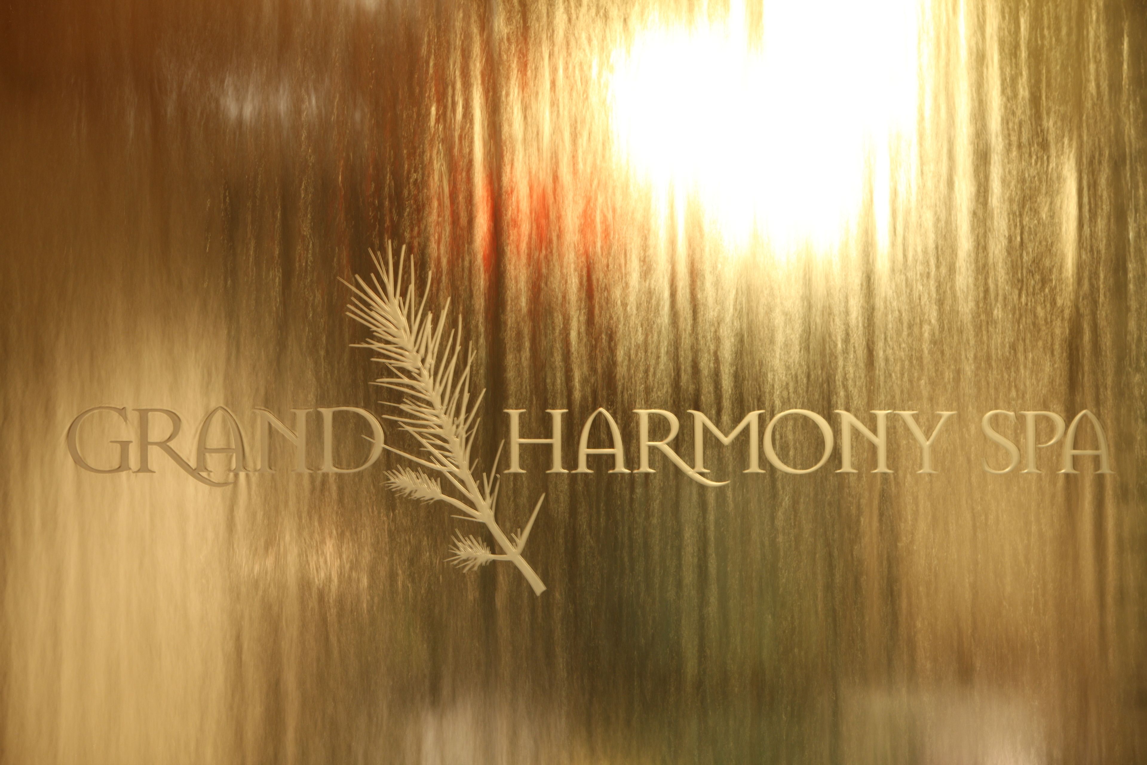 A logo with the text "GRAND HARMONY SPA" and a decorative element.