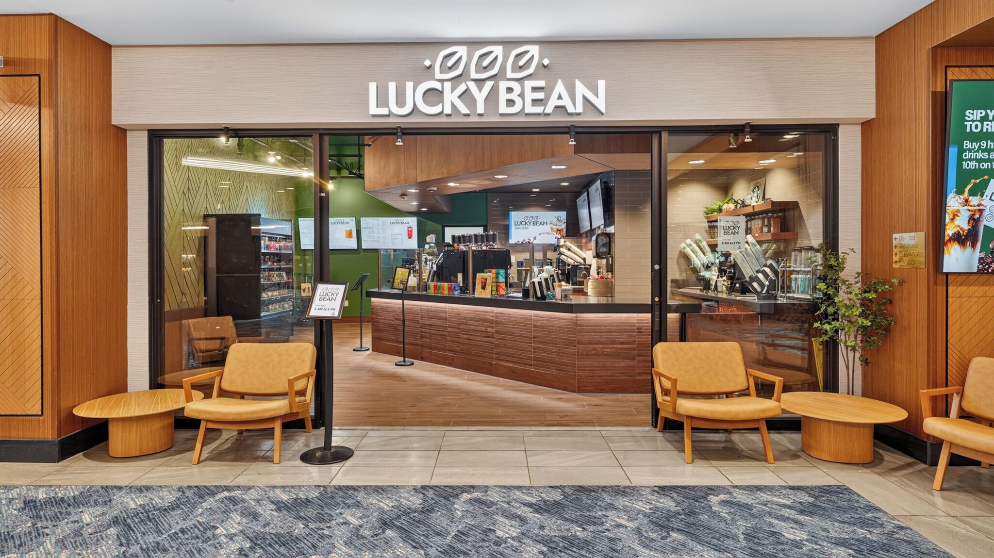 A Lucky Bean coffee shop with a modern interior, seating area, and a counter with coffee-making equipment.