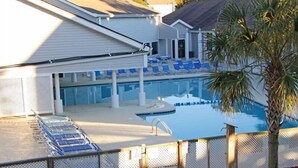 A swimming pool with lounge chairs and a covered area. - Lake Arrowhead Den (Myrtle Beach)