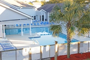 A swimming pool with lounge chairs and a palm tree. - Lake Arrowhead Headquarters (Myrtle Beach)