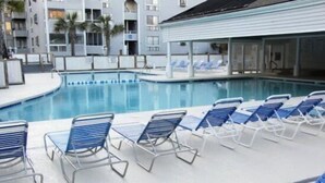 A swimming pool with lounge chairs and a covered area. - Lake Arrowhead Casa (Myrtle Beach)
