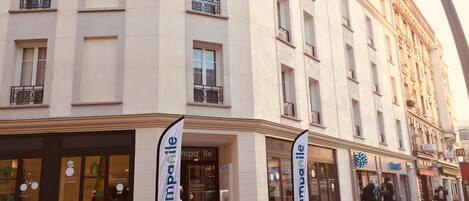 A building with multiple storefronts, including a visible 'Campanile' sign.