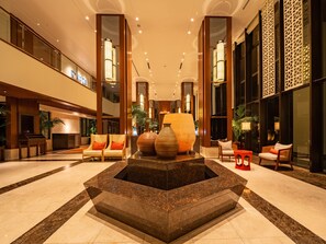 A spacious lobby with a central water feature, seating areas, and a modern design. - Hyatt Regency Naha, Okinawa (Naha)