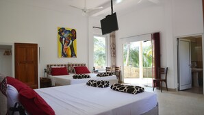 A hotel room with two beds, a TV, a painting, and a view of the outdoors. - Hilltop Boosa (Boossa)
